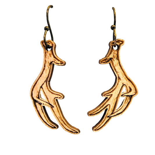A pair of dangling earrings shaped like stylized deer antlers, made of textured gold-toned metal with dark hooks, shown on a plain white background.